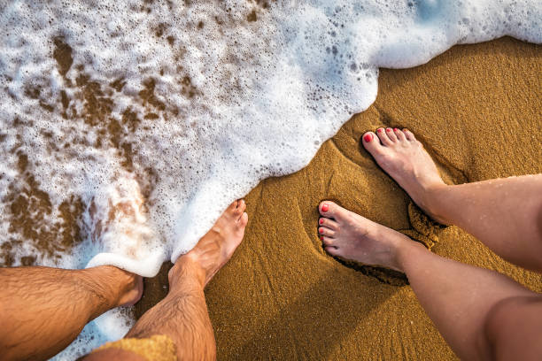 couple legs on the beach
