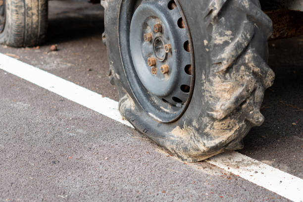 istock Flat tire of tractor on asphalt road 1263640372