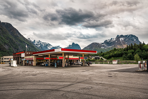 gas station and mountains under cloudy sky