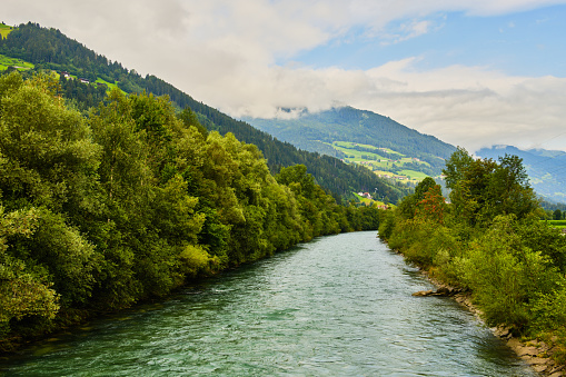 River Ziller on way from Stumm Ahrnbach to Kaltenbach surounded by trees in Zillertal valley, Austria