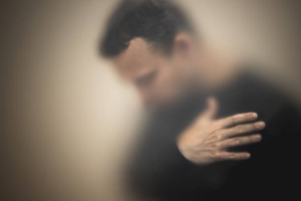 istock Sad man hold his hand behind matte glass wall 1263640507