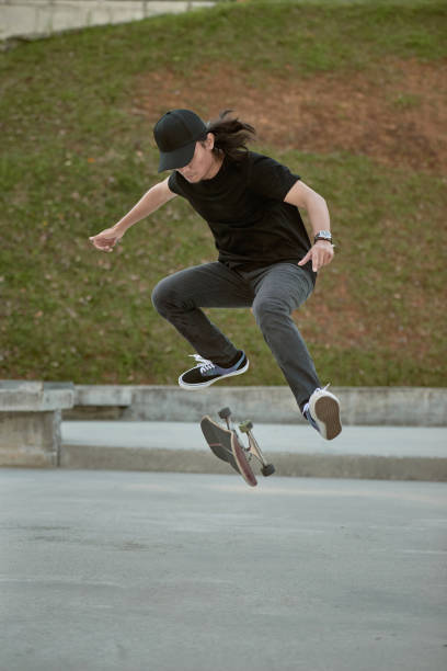 istock Asian skateboarder in action 1263641414