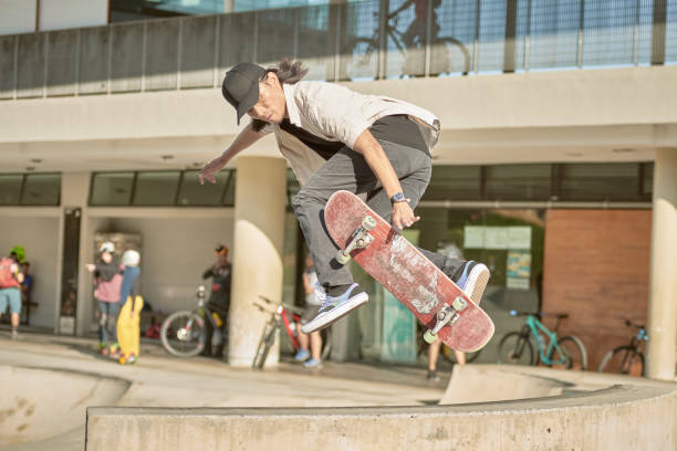 istock Asian skateboarder in action 1263641425