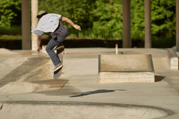 istock Asian skateboarder in action 1263641443