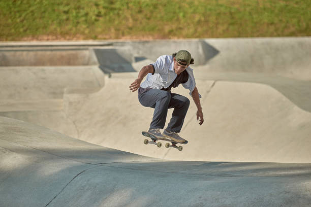 istock Asian skateboarder in action 1263641919
