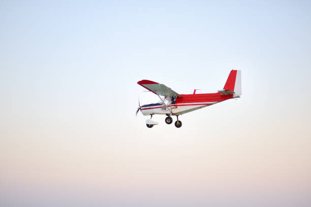 istock Small ultralight airplane with overhead wing and single propeller flying in sky. Such aircraft are used for recreational, sport and flight training. 1263641990
