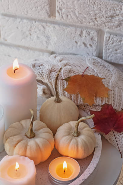 istock Autumn decor with white pumpkins and burning candles 1263642520