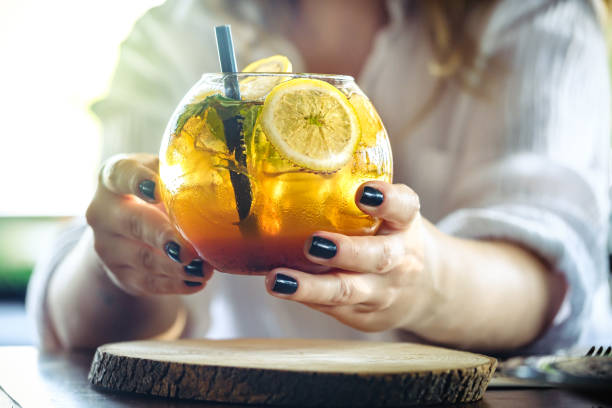 istock Woman hand holding iced yellow cocktail 1263642918