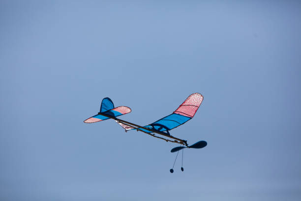 istock Rubber powered glider flying in the sky. model airplane. 1263644224