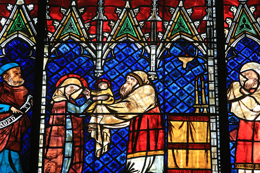 Europe. France. Alsace. Bas-Rhin. Strasbourg. 05/28/2014. This colorful image depicts the Presentation of Jesus in the Temple. Details. Large 14th century glass roof representing the life of the Virgin Mary and the childhood of Christ, window on the south aisle of the nave. First glass roof from Saint Catherine's chapel. Between 1332 and 1349. Our Lady of Strasbourg Cathedral.