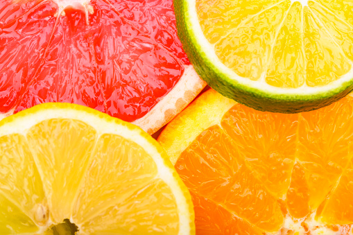 Colorful Citrus fresh fruits including grapefruit, lime, lemon and orange cross section studio shot