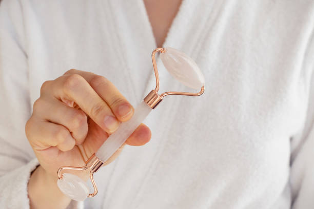 istock Woman's hand holding facial jade massage roller 1263646584