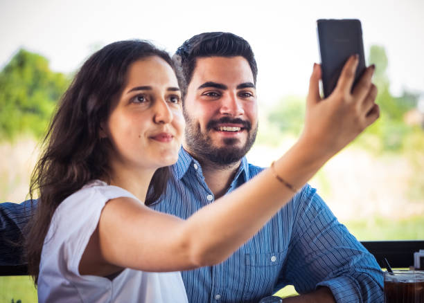 istock Young couple taking a selfie 1263648221