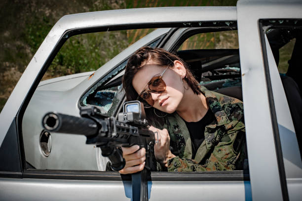 istock Attractive female soldier had shooter courses. Shooting from car training 1263650203