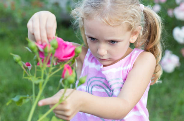 istock Little girl plays with a flower. 1263651646