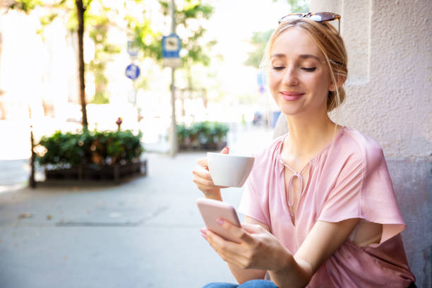 istock Young woman having cafe and text messaging while sitting at outdoor cafe 1263653226