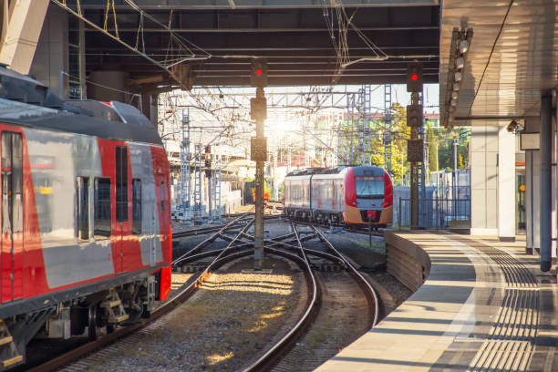 istock Suburban speed express train leaving the station, empty platform. Another train waiting for passengers. 1263653314