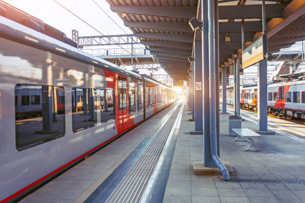 istock Suburban express train leaves the station, empty platform. 1263653347