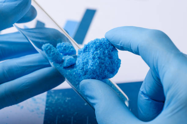 istock Crystal material in hand and glass test tube 1263654998