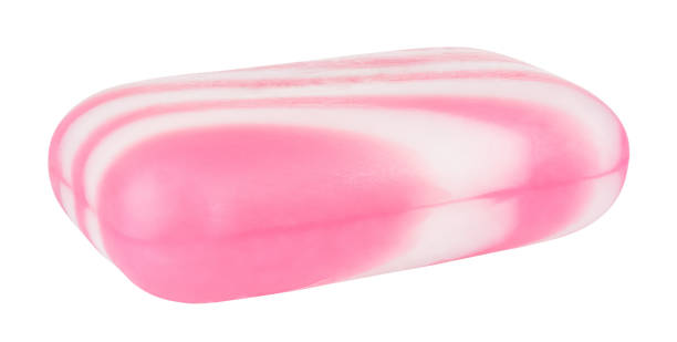 istock Soap with white and pink stripes isolated on white background 1263658460