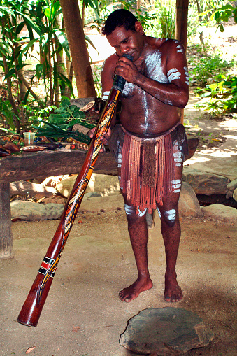 Kuranda, QLD, Australia - March 01: Unidentified aborigine with body painting playing his traditional didgeridoo