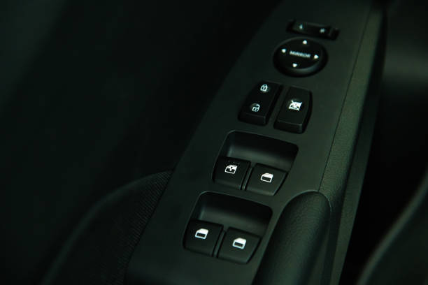 istock Car interior details of door handle with windows controls and adjustments. Car window controls 1263663187