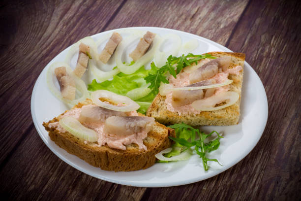 istock sandwich with salad, herring and herbs with onions in a plate 1263664701
