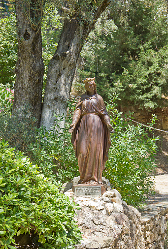 Virgin Mary Sculpture With Cross At The Garden Of Virgin Mary House At Ephesus and Wishes wall at courtyard of House of the Virgin Mary, Mt. Koressos, Ephesus, Selcuk, Turkey