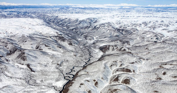 istock Panorama of snow-capped mountains from a helicopter. 1263670398