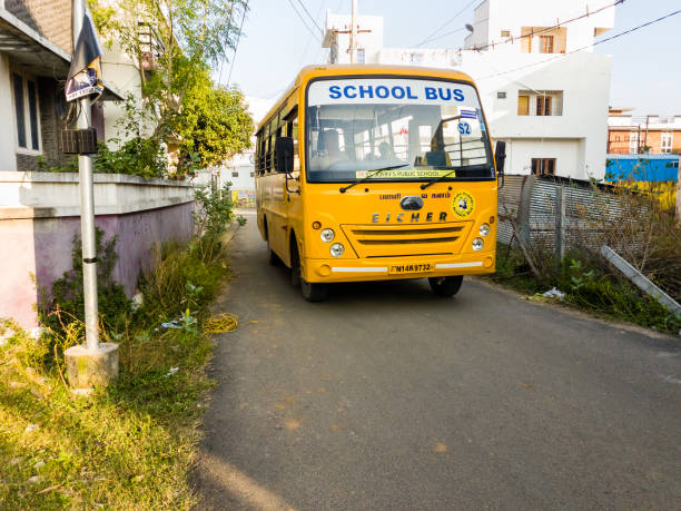 A yellow school bus on the road Chennai, Tamil Nadu, India - January 2020: A yellow school bus transporting children to school in suburban Chennai. chennai photos stock pictures, royalty-free photos & images