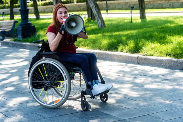 istock Disabled girl with a megaphone in her hand 1263673096