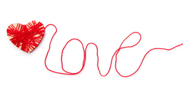 istock Hearth and word Love made with red thread isolated on white background 1263674143