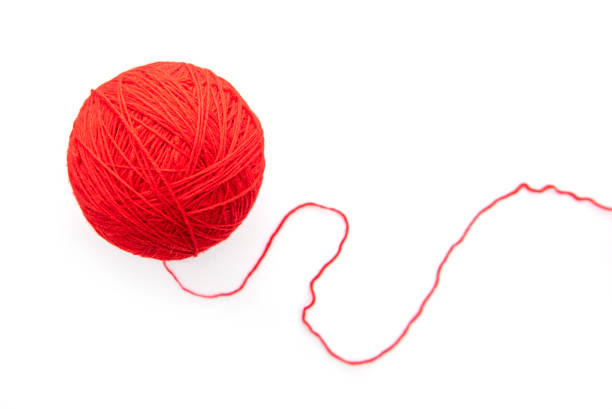 istock Red ball with woolen threads isolated on white background 1263674145
