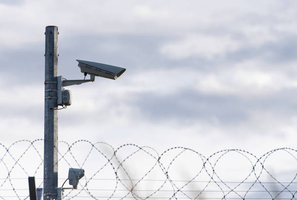 istock Surveillance Camera and barbed wire, border, prison, concept picture 1263674146