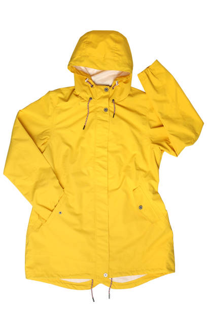 Yellow hooded raincoat Yellow hooded raincoat on  isolated on white background raincoat stock pictures, royalty-free photos & images