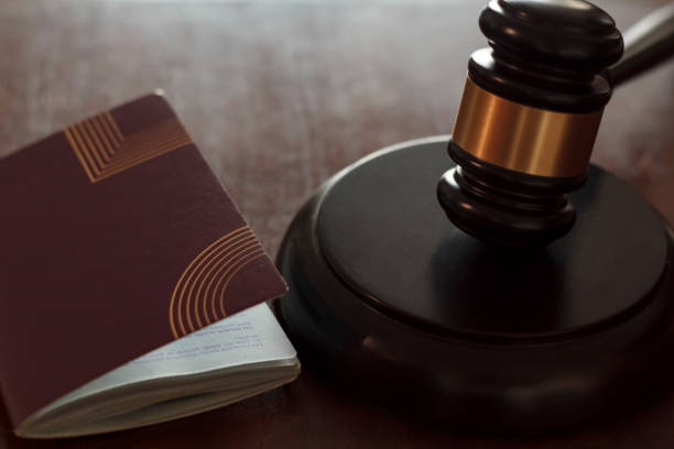 istock Judge's gavel and passport on wooden table 1263675180