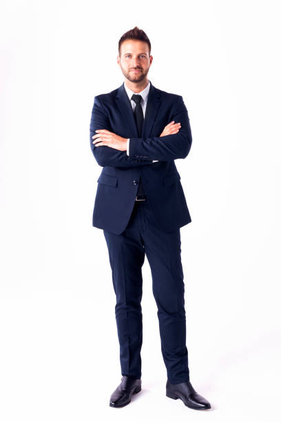 istock Confident businessman wearing suit while standing with arms crossed at isolated white background 1263676944