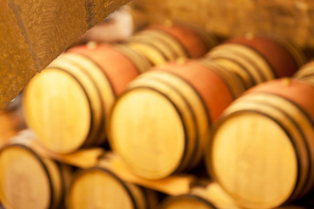 View in an old wine cellar with blurred wine barrels in the background - selective focus on the stones in the foreground