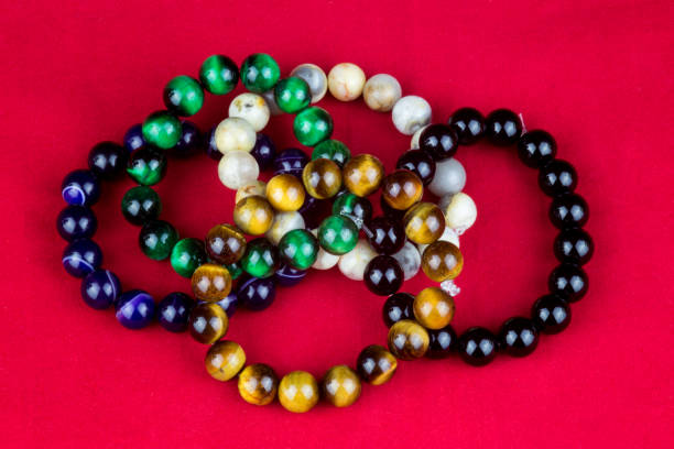 istock Stone Bead Bracelets on a Red Background 1263680513