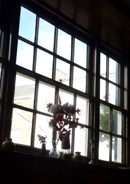 istock Vases with flowers by the window 1263681394