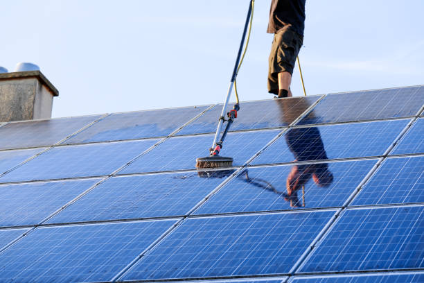 istock Cleaning solar panels with brush and water 1263681622