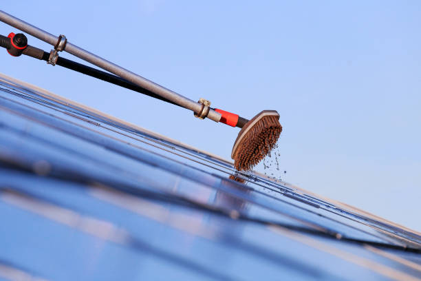 istock Cleaning solar panels with brush and water 1263681748