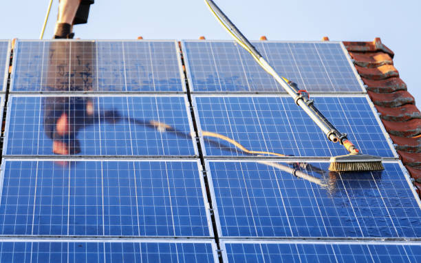 istock Cleaning solar panels with brush and water 1263681837
