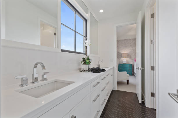istock Chrome faucet in all white bathroom 1263681991