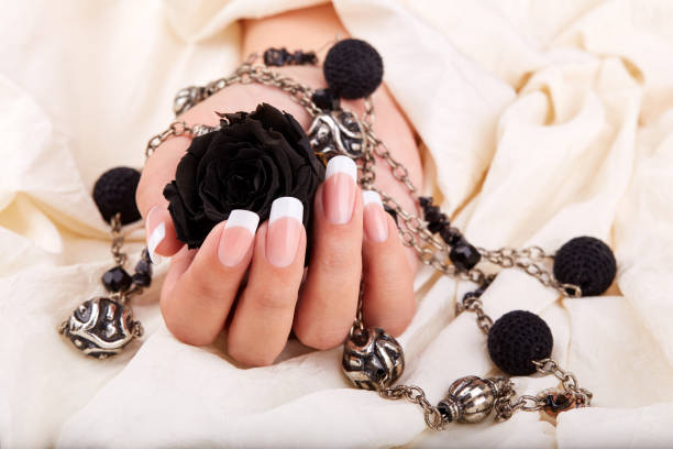 istock Hand with long artificial french manicured nails 1263683621
