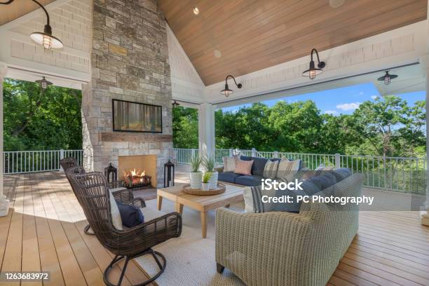 Lakeside Luxury Home With Huge Wood Deck With Beautiful Vaulted Covering And Stone Fireplace Stock Photo - Download Image Now