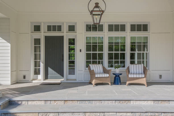 istock Gorgeous front porch with dark colored front door surrounded by windows 1263684602