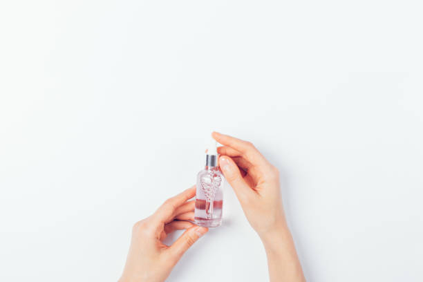 istock Female hands holding cosmetic serum bottle 1263684740