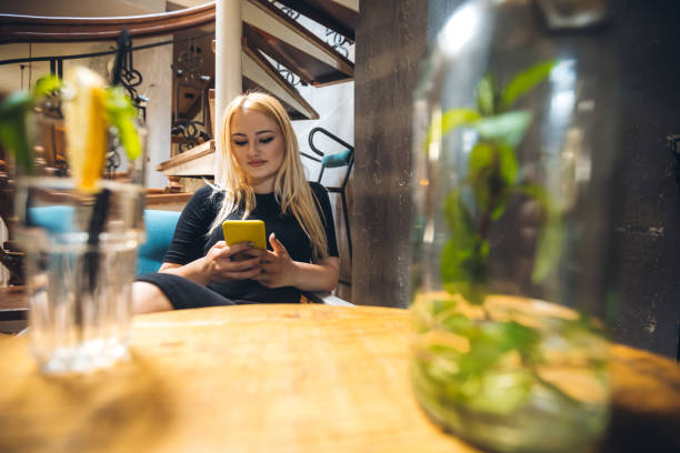 istock Woman texting in cafe 1263686736
