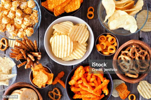 Mixed Salty Snack Flat Lay Table Scene On A Wood Background Stock Photo - Download Image Now